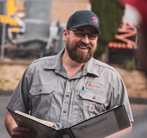 technician smiling with binder